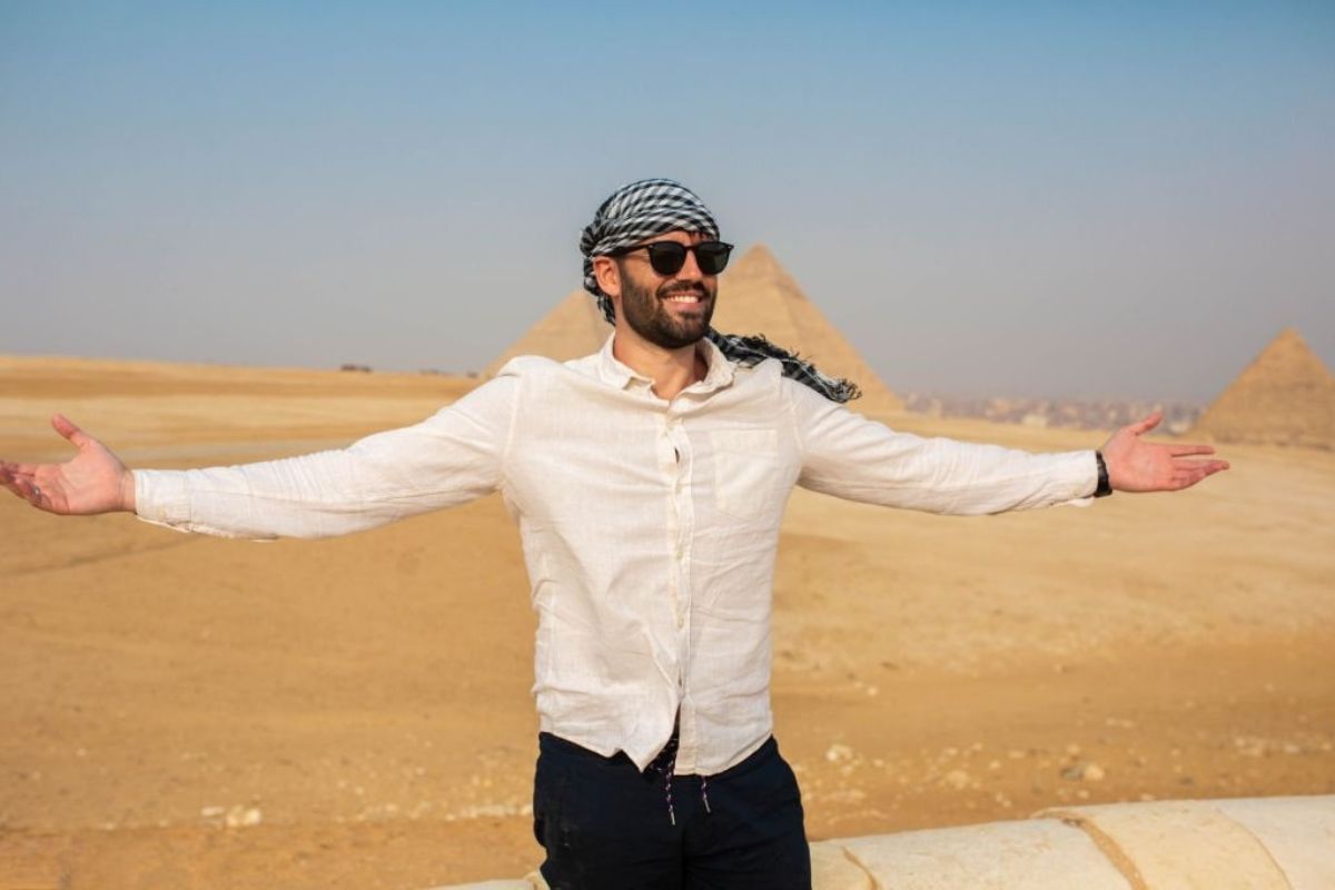 Vast desert dunes stretching endlessly under a clear blue sky creating a stunning golden landscape